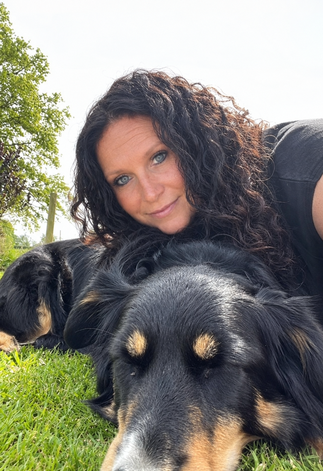 Lou Bailey with her dog resting together in the sunshine